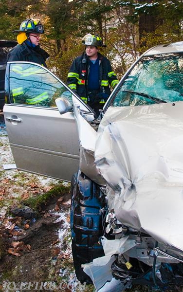 FF Redd and Lt Alba inspect a car that was involved in a car accident on Forrest Ave and Manursing Ave.  Photo by RFD Official Photographer Lester Millman 1/9/15