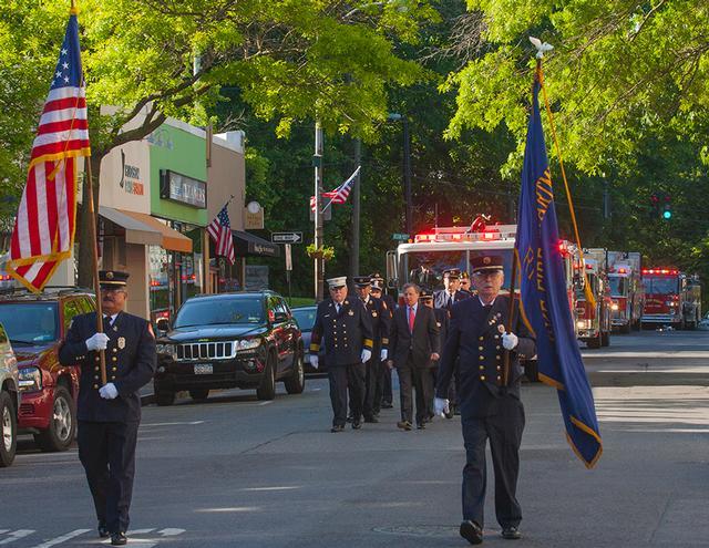 Firefighters and Apparatus march down Purchase St. Photo by RFD FF Lester Millman